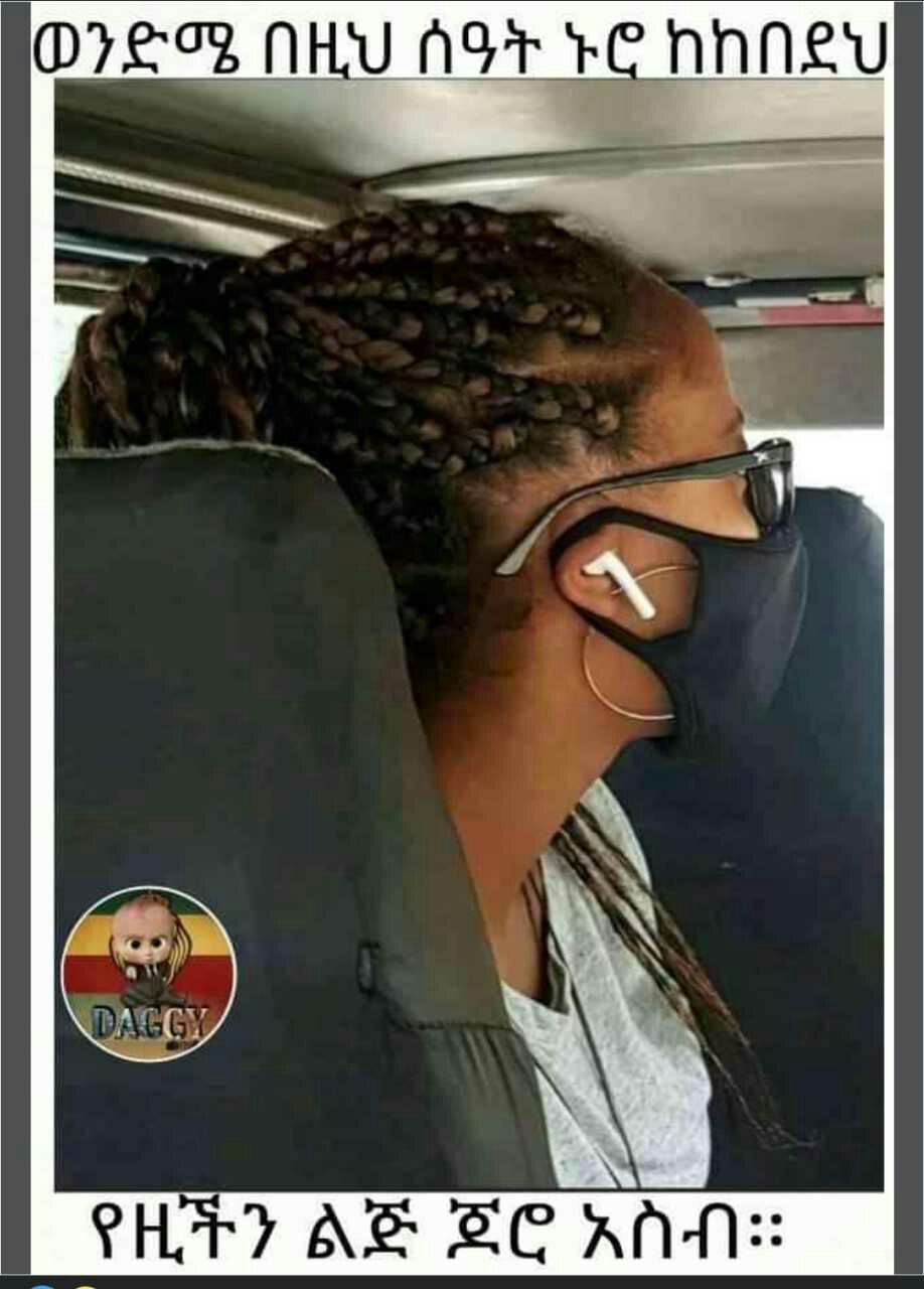 a woman with glasses and a black shirt